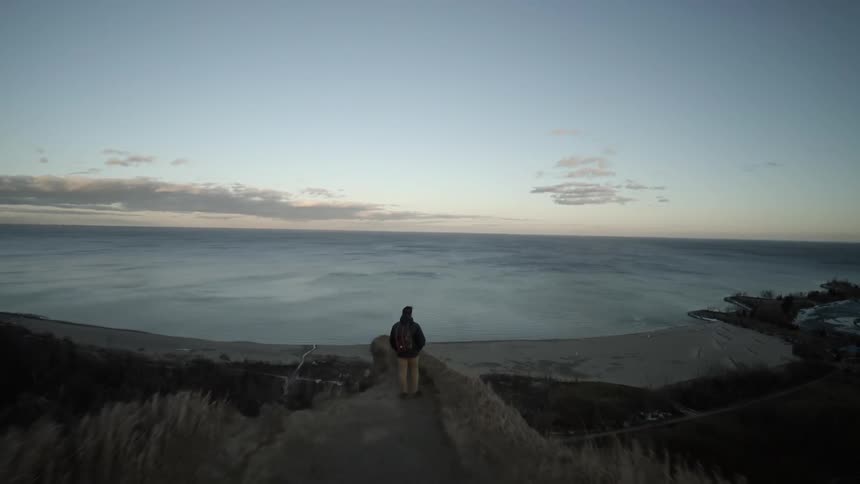 A person sitting on a cliff edge