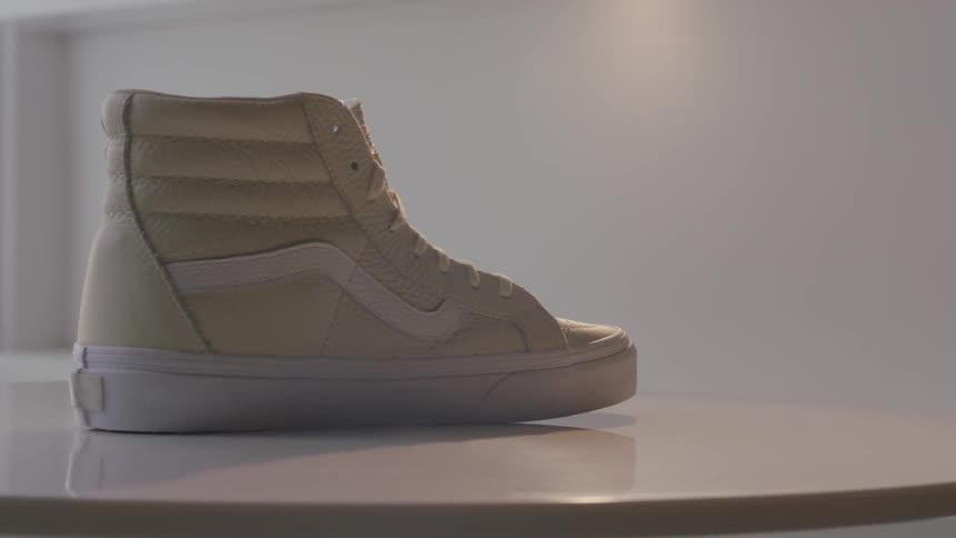 A high top tennis shoe rotates on a table