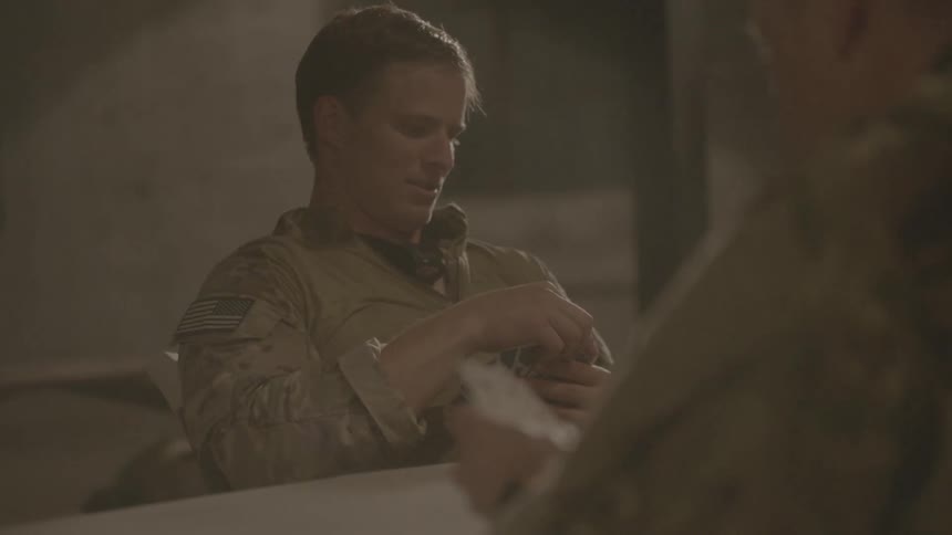 Soldiers play a game of cards
