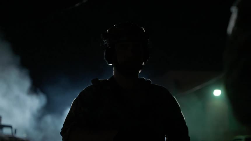Soldier patrols a city at night