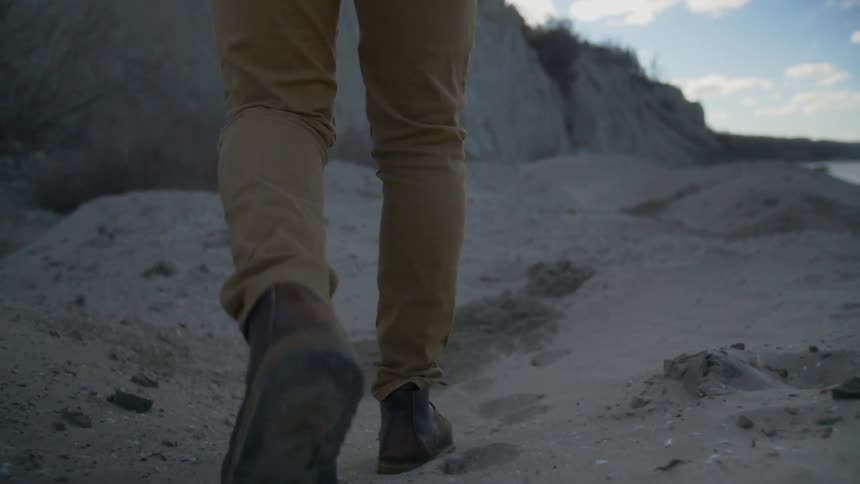 A person walking on sand
