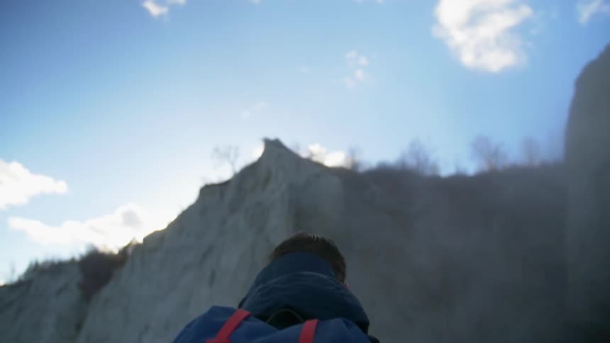 A man hikes near a mountain