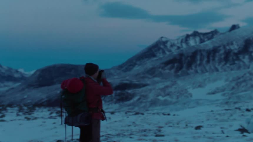 A man is hiking on the mountain taking photographs