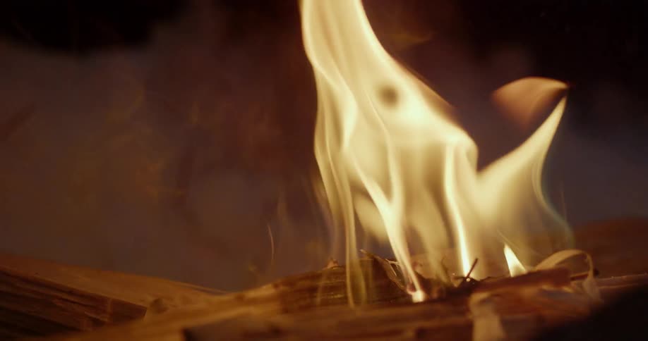 Fire burning on pieces of wood at night