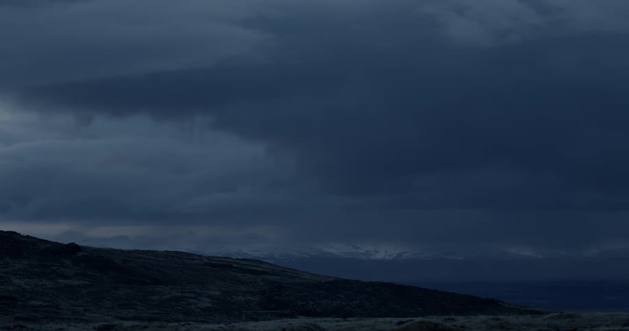 Clouds move over mountains and land