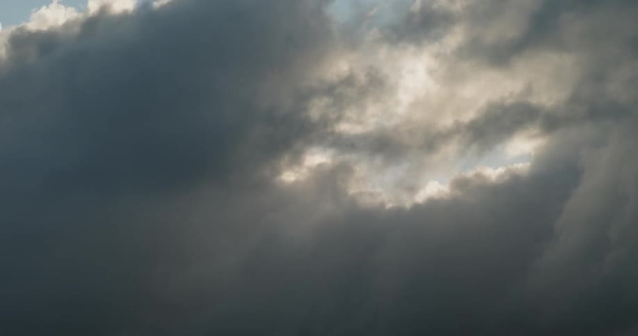 The clouds move fast over the sunny sky