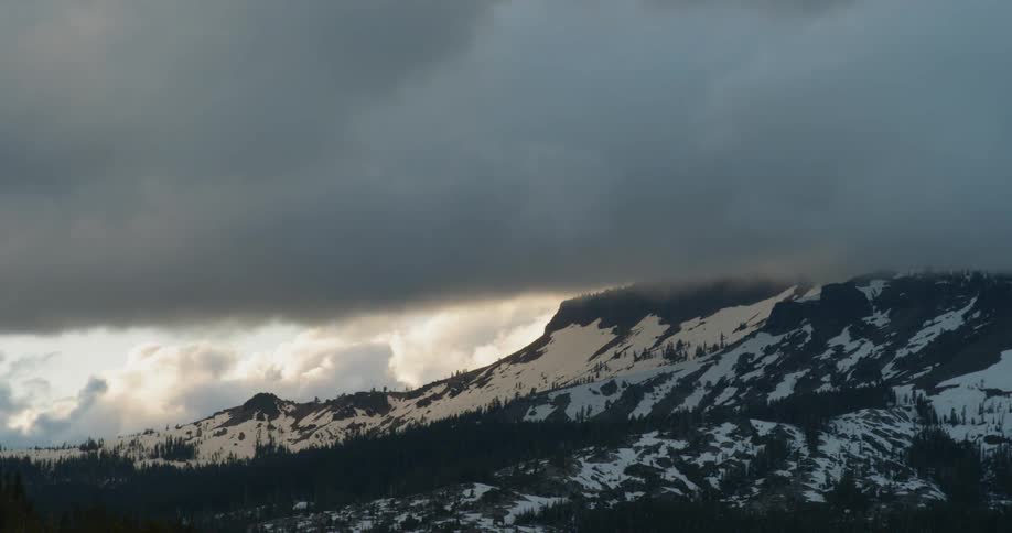 Clouds rolling over a mountain