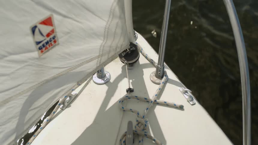 The front of a sailboat gliding over water