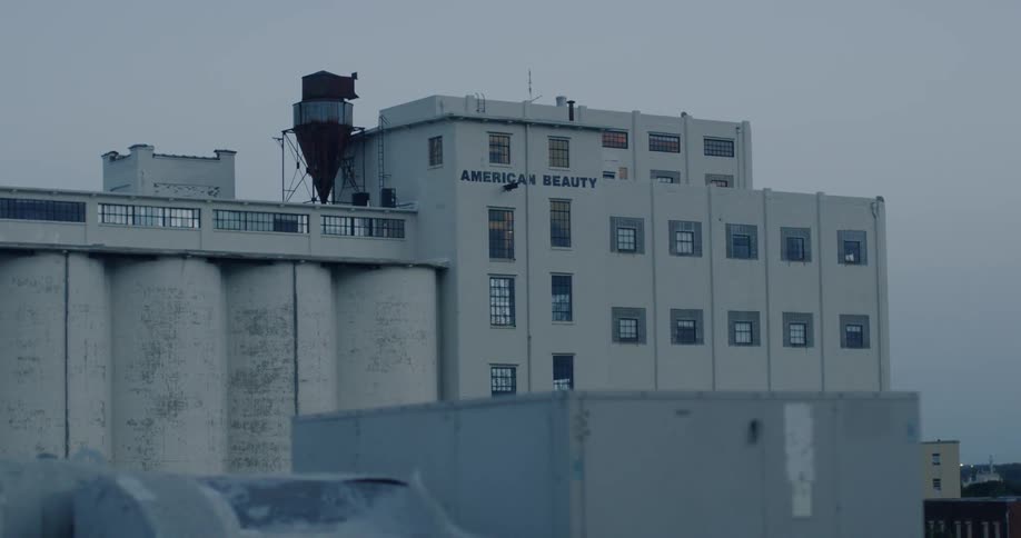 A water tower sits atop an old warehouse building