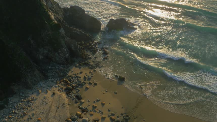 Waves flow onto the rocky shore