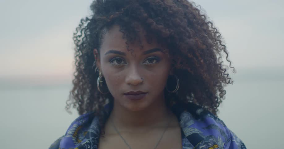 A woman opens her eyes and stares forward