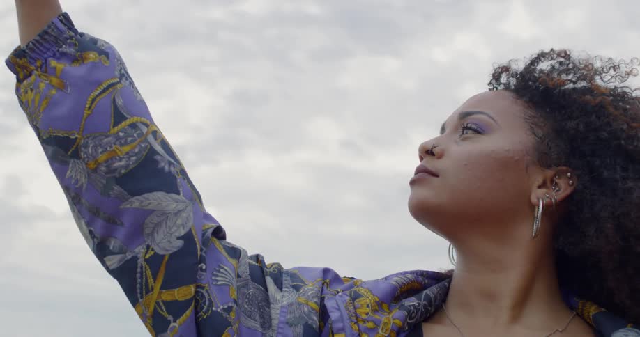 Woman dances outside on a cloudy day