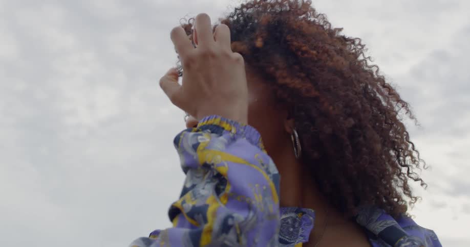 Woman dances outside on a cloudy day