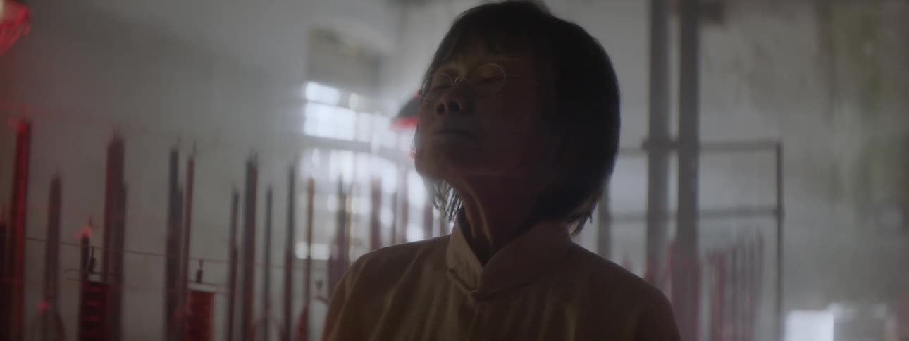 A woman with her eyes tightly shut slowly opens them