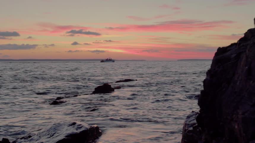 Ocean waves ripple and flow at sunset