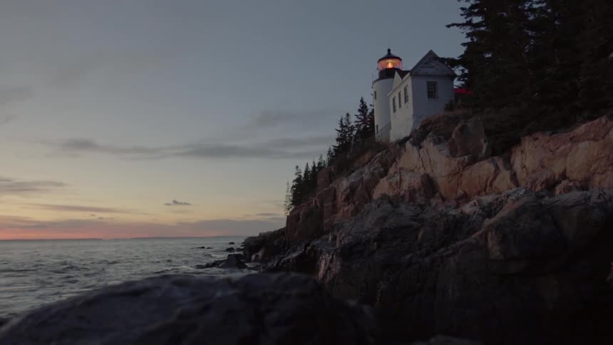 A Lighthouse Stands Tall On An Ocean Cliff
