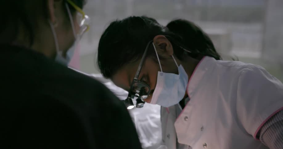 A dentist works on a patient