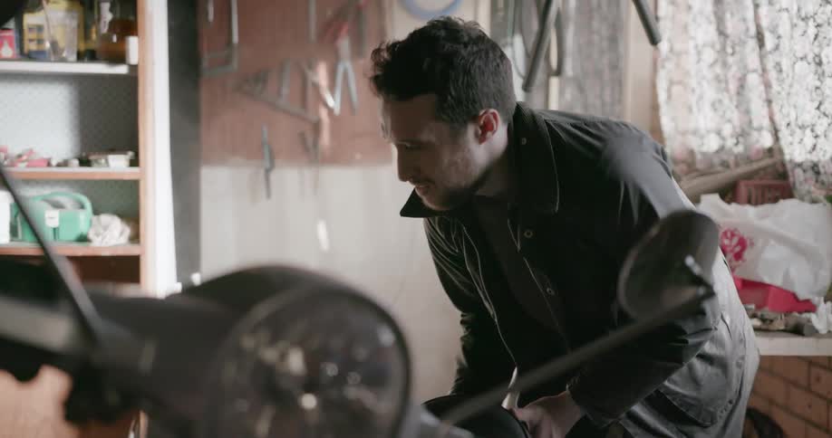 A man is working on his motorcycle