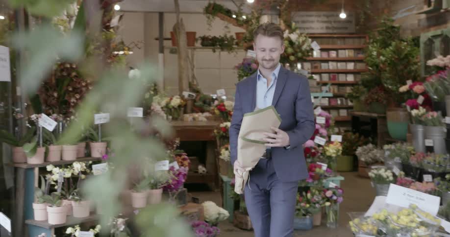 A man buys a bouquet of flowers from a florist