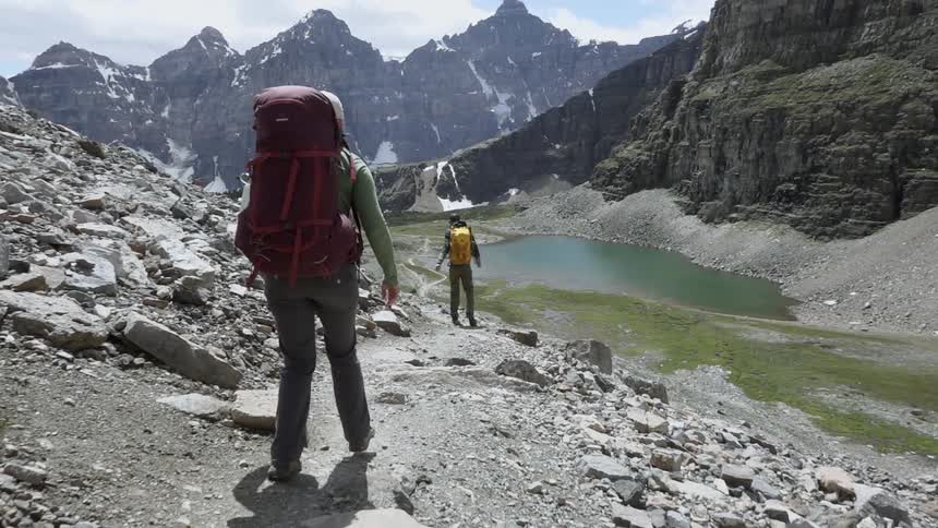 Two hikers travel down the mountain range