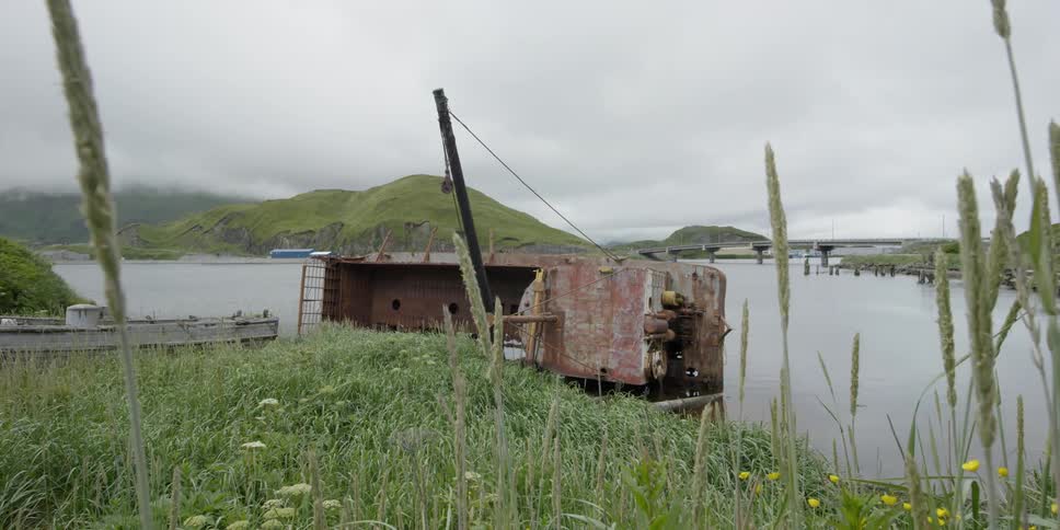 An old structure sits next to a bay