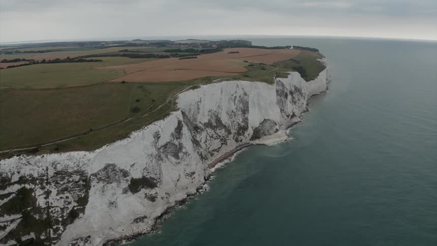 A steep cliff borders an ocean