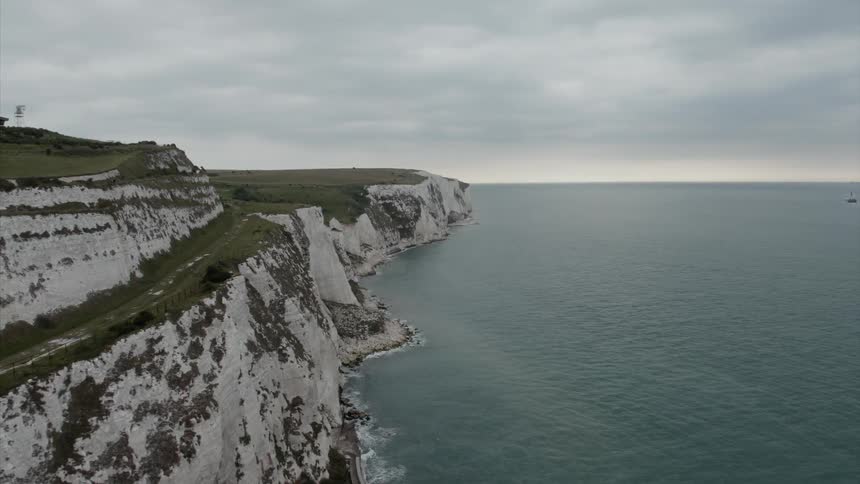 A steep cliff borders a seashore