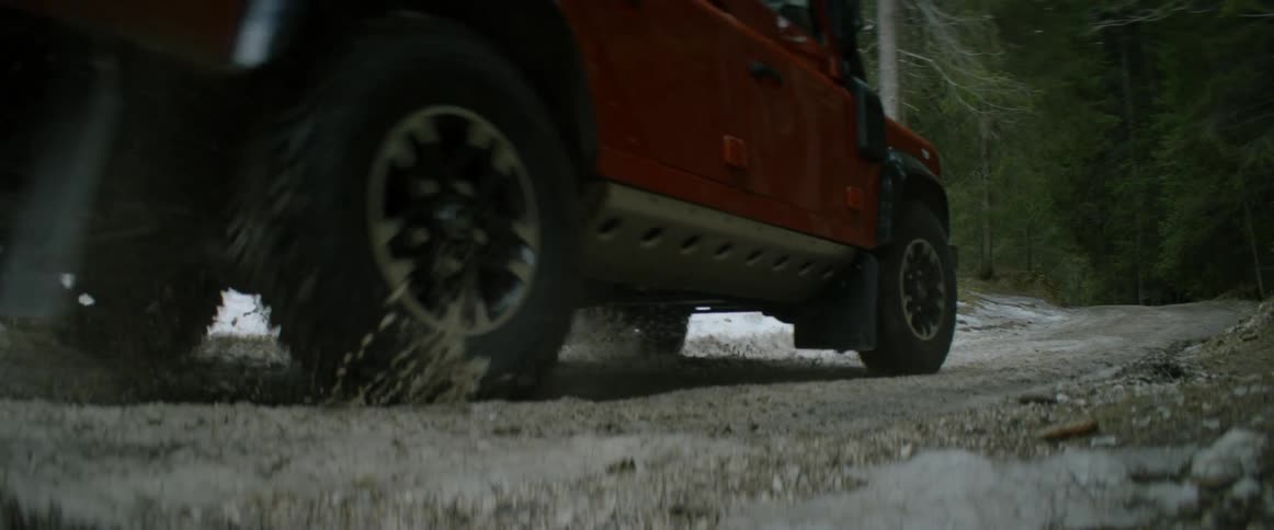 A jump driving down a snow covered road