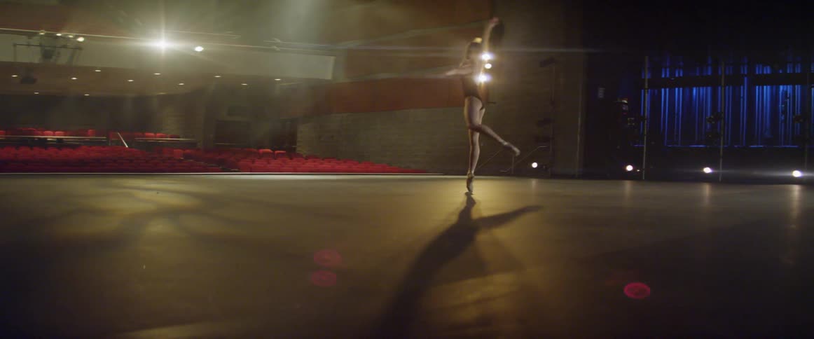 A ballerina dances on stage