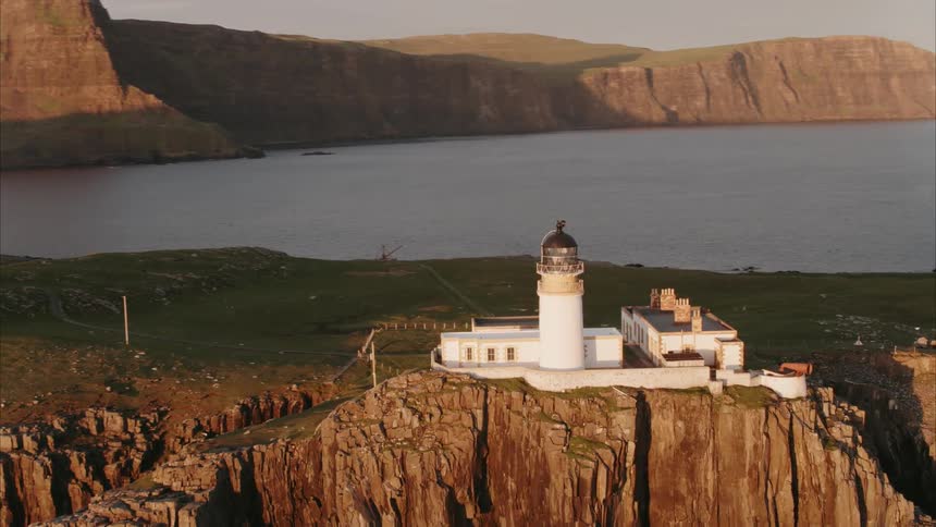 A lighthouse sits perched on a cliff