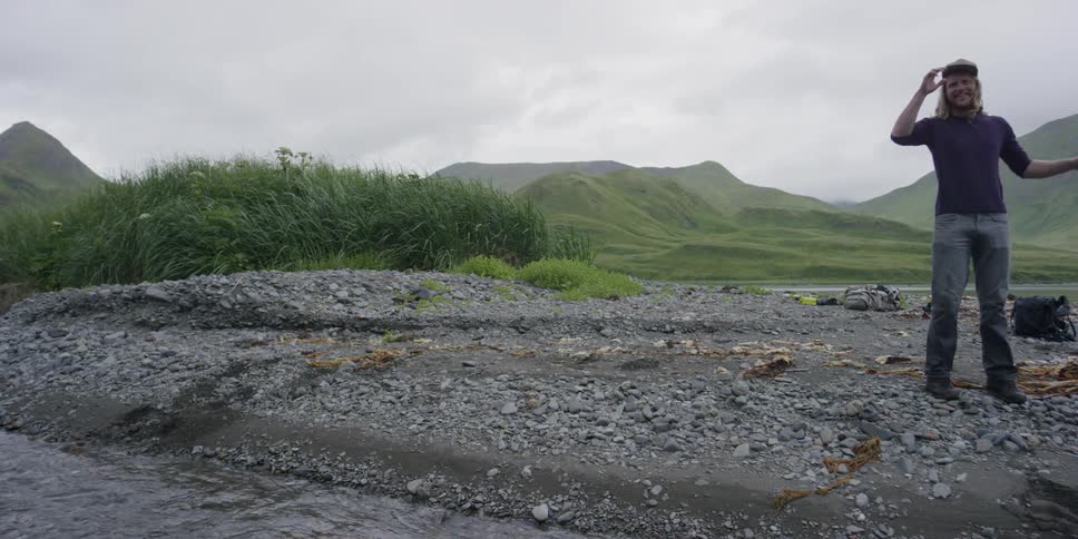 A man walks near a river