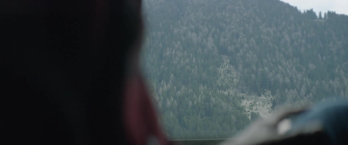 A person drives in the mountains
