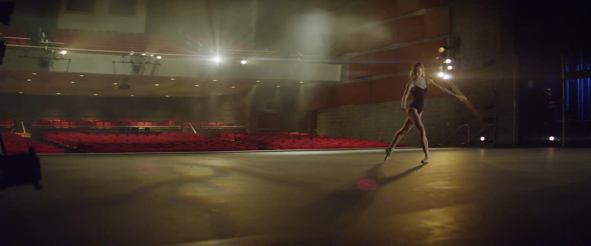 A ballet dancer is dancing on stage