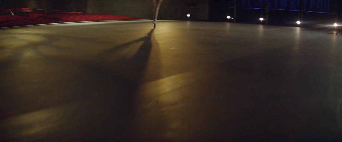 A ballerina twirls on stage