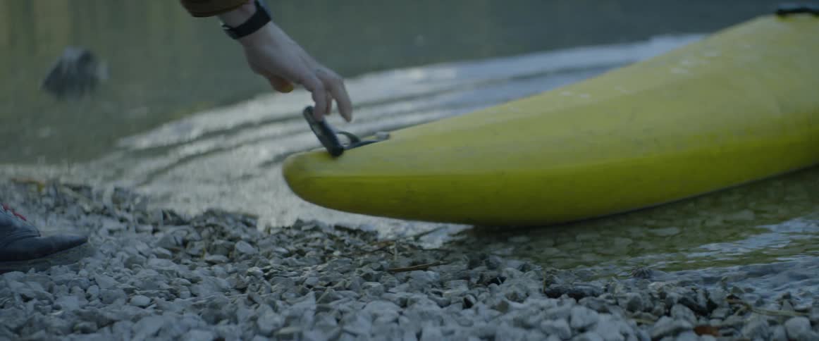 A yellow canoe pushes off into the water