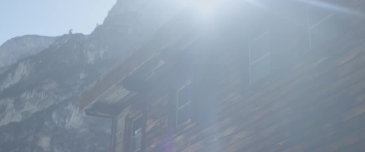 Sunlight shines over an old wood building