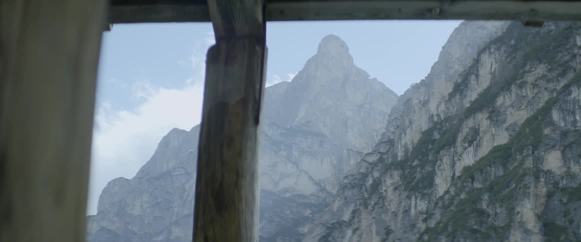 Large mountain outside a cabin on cloudy day