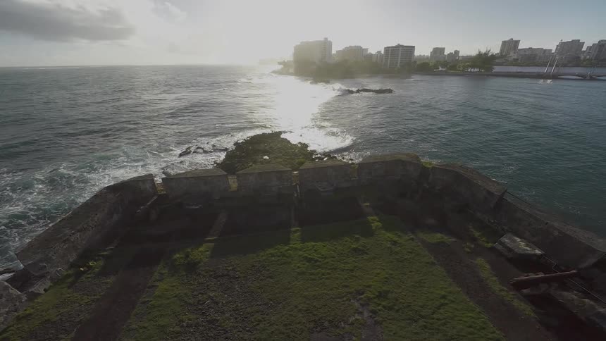 Aerial view of a rock structure with a city in the distance