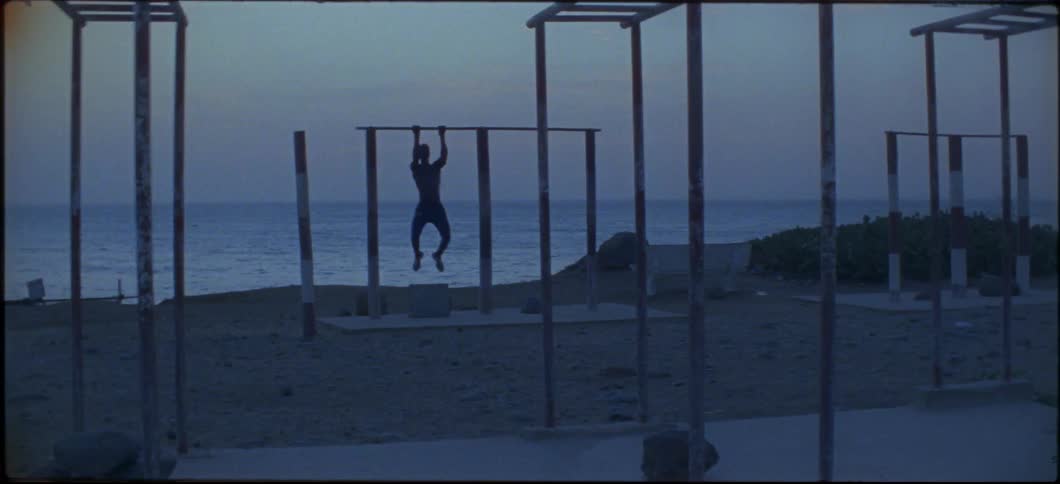 Someone is doing pull ups on the beach
