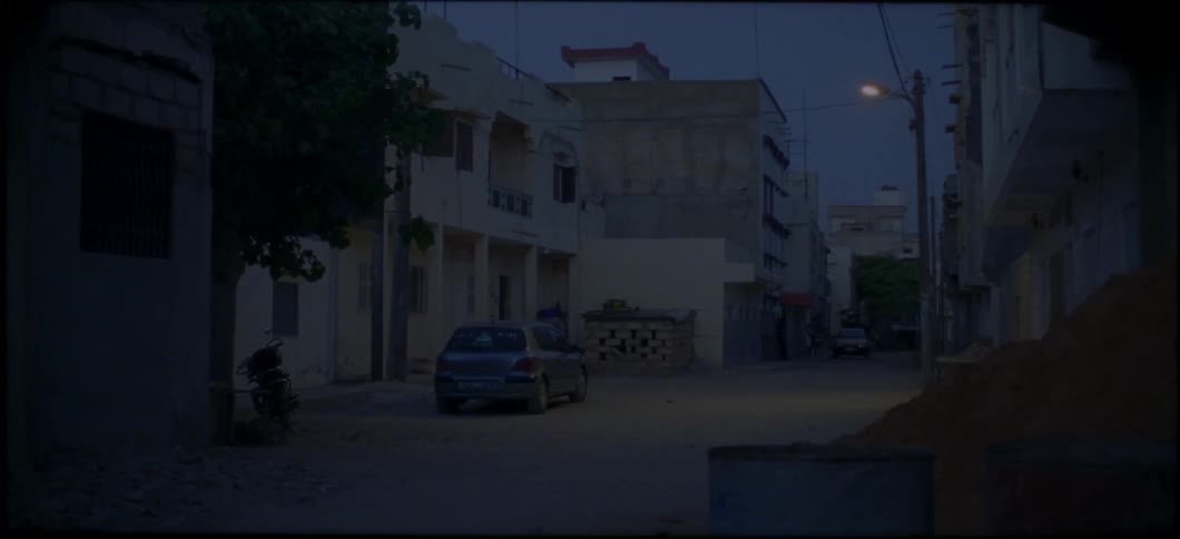 A man comes running down the dark street