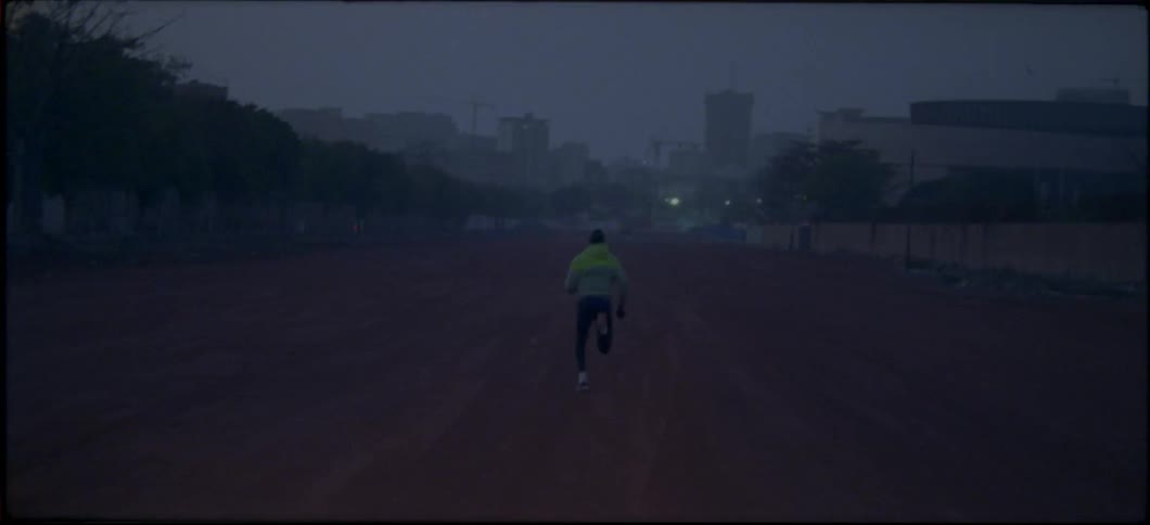 A man jogs down a dirt path