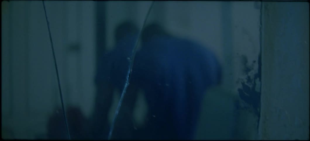 A man is reflected in a broken mirror