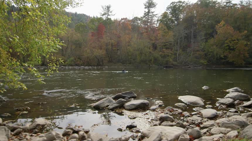 A man kayaks down the stream