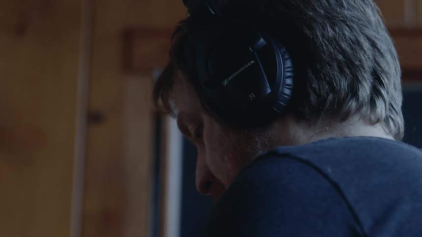 A man wears headphones inside