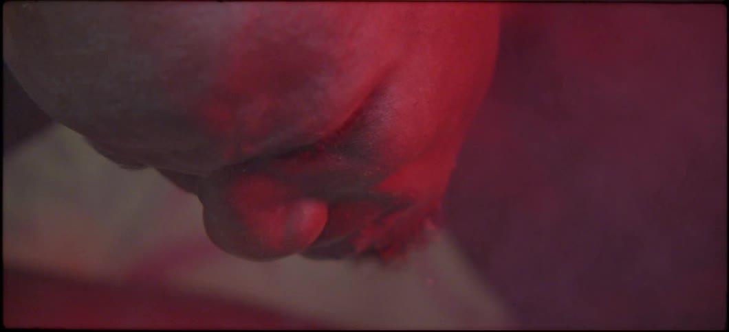 A man is holding his head over a steaming pot