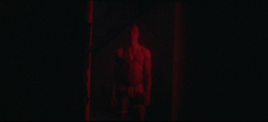 Man stands still in red light
