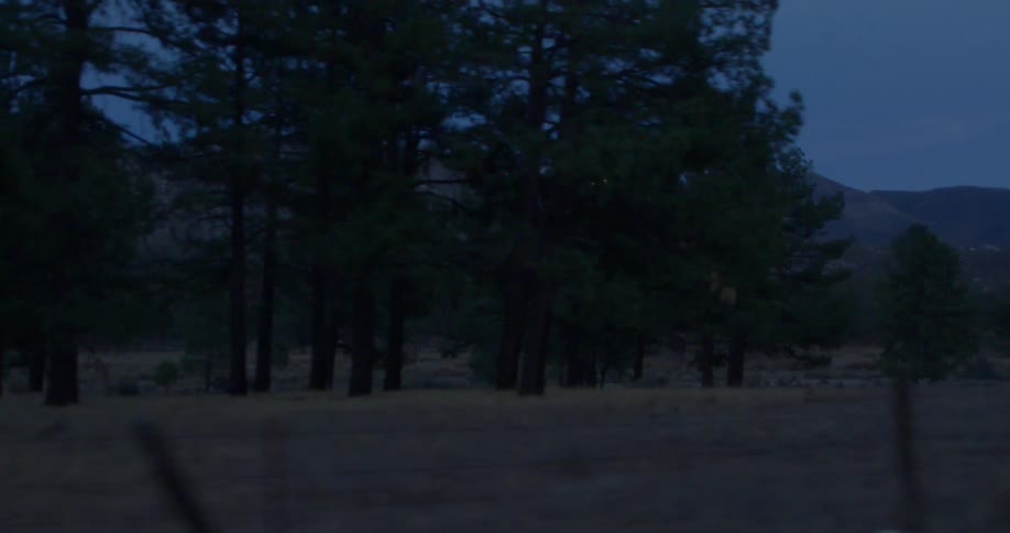 The moon rises over a mountain