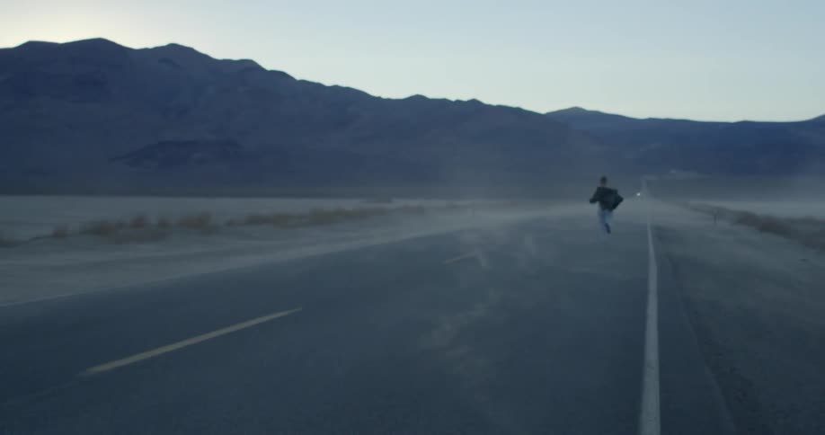 Person runs down a country road