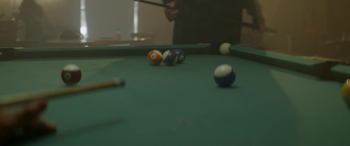 Woman plays pool in a bar