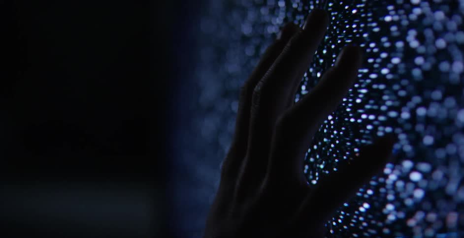 Person touches a static riddled television screen